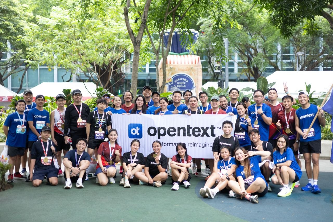 OpenText Philippines employees with race medals after a company fun run